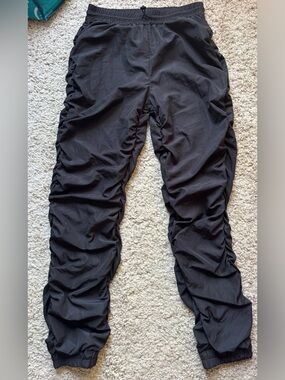 Black nylon parachute windbreaker pants